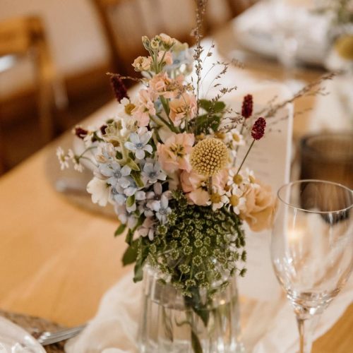 Kleine Vase mit Blumen als Tischdekoration